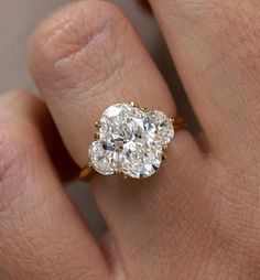 a woman's hand with a diamond ring on it