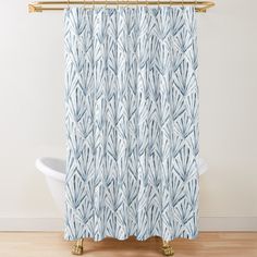 a blue and white shower curtain hanging on a wall next to a bathtub in a bathroom