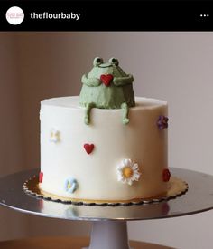 there is a cake with a frog on top