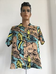 This is a rare print in fabulous colours. Keoni of Hawaii original designed by John Meigs produced by Sun Surf. Amazing Gauguin influenced graphic design print in black background with tan, turquoise and yellow in great condition. Single flat fronted pocket with wooden buttons in 100% Rayon.  Label says M, measurements:  Shoulder to shoulder: 18.5 inches Pit to pit: 22.5 inches Length: 28 inches Sold as seen. No returns. Please contact seller for further info. Retro Green Printed Tops, Retro Printed Shirt With Camp Collar, Multicolor Retro Print Cotton Hawaiian Shirt, Multicolor Cotton Hawaiian Shirt With Retro Print, Retro Multicolor Camp Shirt With All Over Print, Retro Tops With All Over Print And Camp Collar, Multicolor Retro Print Short Sleeve Shirt, Short Sleeve Shirt With Retro Multicolor Print, Yellow Retro Print Short Sleeve Shirt