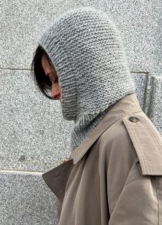 a person wearing a gray knitted hat and jacket