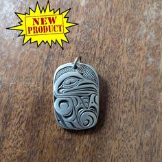 In the shape of a Haida Raven - A symbol of knowledge and creativity. This pendant is in the Formline Art technique unique to the Indigenous Peoples of the West Coast of Turtle Island. The picture represents the story of Raven Stealing the Light, part of the creation narrative of the Haida People. A striking high quality pewter (lead free) pendant. The pendant is a rectangular shape with rounded corners.  The round bale is steel and has a 5 mm opening. Handcrafted by the Canadian Frederick Desig Artistic Etched Jewelry For Gifts, Symbolic Engraved Dog Tag Jewelry, Symbolic Engraved Dog Tag Necklace, Artistic Stamped Jewelry As Gift, Artistic Stamped Jewelry For Gifts, Symbolic Stamped Pendant Jewelry, Handmade Symbolic Jewelry With Oval Pendant, Etched Pendant Jewelry For Commemoration, Handmade Dog Tag Jewelry Gift