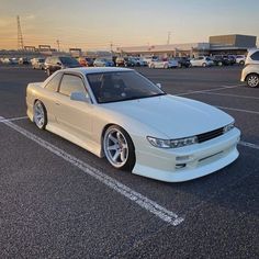 a white car parked in a parking lot