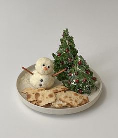 a white plate topped with crackers and a snowman