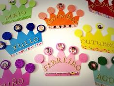 a group of different colored paper crowns sitting on top of a white surface with words written in spanish