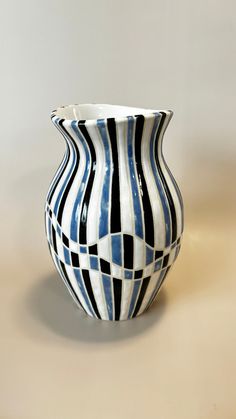 a black and white vase sitting on top of a table