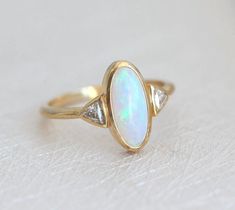 Best seller at Capucinne - Gorgeous one of a kind Australian oval opal & diamond ring perfect as a wedding or engagement ring. Available in 18k yellow gold as seen online. If you would like to have other gemstones instead of diamonds/opals Opal Ring Engagement, Gold Wrap Ring, Australian Opal Ring, Opal Diamond Ring, Opal Engagement Ring, Opal Engagement, Engagement Rings Opal, Morganite Engagement, Morganite Engagement Ring