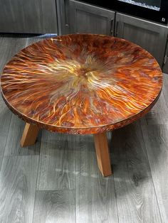 a wooden table with an artistic design on it