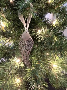 an ornament hanging from the top of a christmas tree