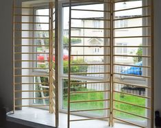 an open window with wooden slats on it