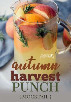 an autumn harvest punch with apples, oranges and rosemary