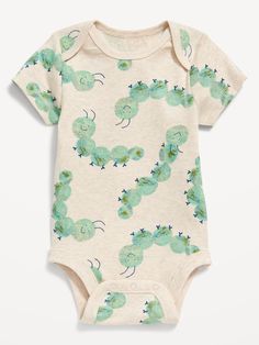 a baby bodysuit with green and blue caters on it's chest, in front of a white background