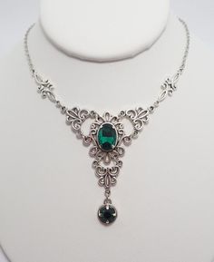 This is a new handmade necklace. It is made with antiqued silver plated filigrees, accented with high quality EMERALD GREEN glass jewels/rhinestones that sparkle like crystals. Decorated portion is 4 1/2" wide and 2 1/4" tall in the center. Necklace is adjustable 15-18" with a lobster clasp and chain extender. If you would like a different length, please send us a message.Matching earrings and headpiece are listed in our store in a variety of stone colors. If you don't see items with a color you Victorian Style Nickel-free Necklace For Weddings, Victorian Wedding Necklace Nickel-free, Victorian Wedding Necklace Nickel Free, Victorian Style Nickel-free Wedding Necklace, Victorian Nickel-free Wedding Necklace, Ornate Filigree Silver Bridal Necklace, Antique Silver Bridal Necklace With Intricate Design, Wedding Filigree Metal Necklaces, Ornate Silver Bridal Necklace