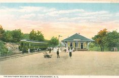 an old postcard shows people walking near a train station