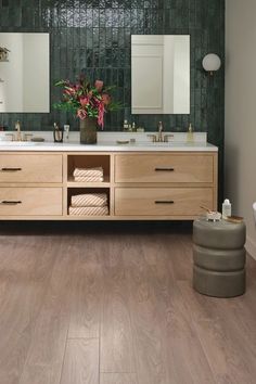 a large bathroom with two sinks and mirrors