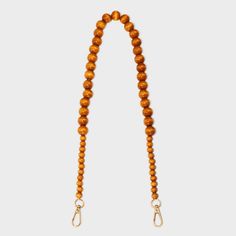 Add some natural, boho vibes to your bag with this Beaded 29.5-Inch Shoulder Purse Handbag Strap from A New Day™. This handbag strap is made of larger brown beads flanked by smaller beads on both sides, with gold-tone hardware, allowing you to showcase your unique sense of style. The 29.5-inch length allows for comfortable shoulder carrying, and the lobster-claw clasps make it simple to attach to your preferred handbag. A New Day™: Style that goes wherever you do. Everyday Beaded Tote Shoulder Bag, Everyday Rectangular Shoulder Bag With Colorful Beads, Everyday Beaded Shoulder Bag, Everyday Beaded Crossbody Bag, Gold Beaded Bag For Daily Use, Straw Clutch, Natural Boho, Bungee Cord, Handbag Straps