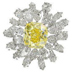 Crafted by Bulgari around 1960, this magnificent brooch epitomizes the essence of timeless glamour and the pinnacle of artisanal craftsmanship. It's not just an accessory; it's a portal to a bygone era when luxury was synonymous with scrupulous attention to detail. At its heart lies an 18.88-carat Cushion Fancy Intense Yellow VS2 diamond, radiating a captivating brilliance. This central diamond is framed by a stunning array of marquis and pear-shaped diamonds, totaling approximately 18 carats, p Vintage Bulgari, David Webb, Vs2 Diamond, Diamond Brooch, Pear Shaped Diamond, Yellow Diamond, Vintage Diamond, Vintage Brooches, Luxury Jewelry