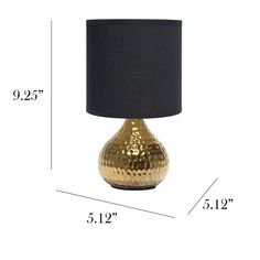 a gold table lamp with black shade and measurements