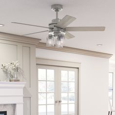 a living room with a fire place and a ceiling fan in the middle of it