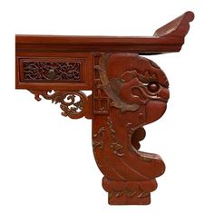 a wooden table with carvings on the top