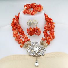 African Wedding Jewelry Catalog | LaceDesign Workshop Elegant Orange Beaded Necklaces With Gemstone Beads, Elegant Orange Gemstone Beads Necklace, Elegant Orange Gemstone Beaded Necklaces, Orange Faceted Beads For Jewelry Making, Orange Faceted Beads Jewelry, Orange Faceted Beads For Crafting, Elegant Orange Jewelry With Stones, Elegant Orange Red Coral Beads, Orange Gemstone Round Beads Jewelry