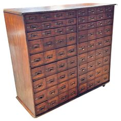 an old wooden cabinet with many drawers