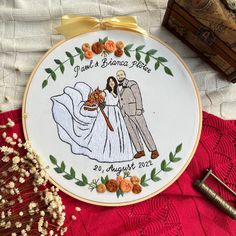 an embroidered wedding ornament with a bride and groom on it