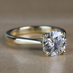 a close up of a ring with a diamond on it