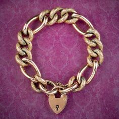 A grand antique Victorian curb bracelet made up of chunky 9ct gold links that have developed a lovely golden-bronze patina with age. The smallest links have been engraved with textured patterning across the top and contrast beautifully against four larger links in between. It's all held by a safety chain and heart padlock clasp which were often gifted by Victorian gentlemen to their loved ones during long periods of separation, as a symbol of the couple's strong commitment to one another.  It's Vintage Gold Chain Bracelet For Anniversary, Gold Charm Bracelet Gift With Clasp, Vintage Yellow Gold Oval Link Bracelet, Vintage Gold Engraved Chain Bracelet, Vintage Gold Curb Chain Bracelet, Heirloom Gold Bracelets With Vintage Charm, Vintage Engraved Gold Chain Bracelet, Vintage Yellow Gold Chain Link Bracelet, Antique Gold Bracelet Gift