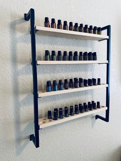 "Have a great metal and wood essential oil shelf. Can make you any size you would like the one in the picture is 4 shelves. 25 oils a shelf totaling 100 oils can make taller, wider or smaller. Where ever it will fit great in your home. Some Assembly required YOU CAN ALSO ORDER WITH NO WHOLES IF YOU WANT AS WELL OR HALF HOLES HALF NOT MESSAGE ME IF YOU WANT THE WOOD A STAINED COLOR OR A DIFFERENT PAINT COLOR THANKS OR IF YOU WANT A METAL RAIL IN THE FRONT ON THE SHELF IT IS IN THE SHELF OPTIONS A Salon Shelving Ideas, Oil Rack, Oil Shelf, Essential Oil Shelf, Candle Bar, Essential Oil Storage, Retail Shelving, Healing Space, Geometric Wall Decor