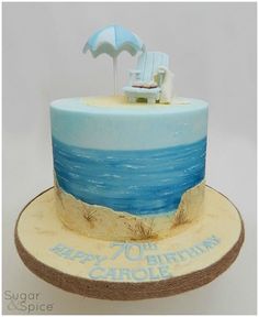 a blue and white cake with an umbrella on top