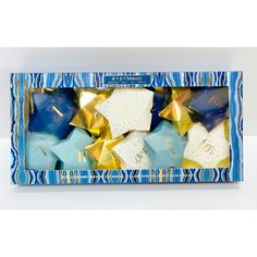 blue and gold star ornaments in a box