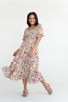 Features Square neck Balloon sleeve with elastic Smocked bodice Ruffled tiered skirt with pockets Vibrant floral print Skirt is lined Dress: 100% Rayon,Lining: 100% polyester Size + Fit Small 0-4, Medium 4-8, Large 8-12 Kristin is 5'4" a size 3 and is wearing a small Runs true to size Size Bust Length Small 34" 42" Medium 36" 43" Large 38" 44" Flowy Floral Dress With Smocked Back And Short Sleeves, Smocked Back Tiered Dress For Garden Party, Flowy Tiered Floral Dress With Smocked Back, Garden Party Tiered Dress With Smocked Back, Tiered Floral Dress With Smocked Bodice For Garden Party, Tiered Dress With Smocked Back For Garden Party, Spring Brunch Tiered Dress With Smocked Bodice, Spring Tiered Dress With Smocked Bodice For Brunch, Casual Dress With Elastic Waistband For Garden Party