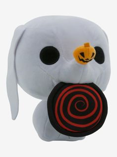 a white stuffed animal with a black and red target in it's mouth