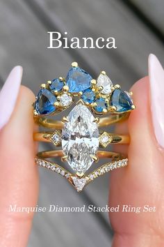 A three ring stack featuring our Bianca - Marquise. This engagement ring oozes vintage flair that is hard to resist. She holds a bright marquise diamond in a vertical position that commands attention. She is topped by our Tiara, our unique band with a cluster of diamonds and sapphires that come together to make something beautiful. Lastly our Kia, the throne for your queen. She features an elegantly contoured band that is approximately 2mm wide. Strange Engagement Rings, Unique Wedding Ring Sets, Marquise Ring Setting, Vintage Wedding Bands, Ring Upgrade, Modern Wedding Rings, Dream Rings, Marquise Ring, Unique Bands