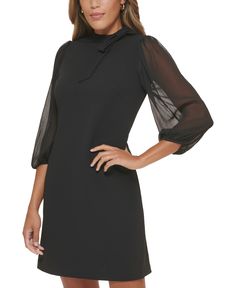 Chiffon puff sleeves lend a fashionable finish to Calvin Klein's tie-neck sheath dress. Chic Formal Puff Sleeve Dress With Blouson Sleeves, Fitted Black Dress With Blouson Sleeves, Black Fitted Dress With Blouson Sleeves, Elegant Dresses With Blouson Sleeves For Work, Black Dress With Puff Blouson Sleeves, Chic Black Dresses With Blouson Sleeves, Chic Black Dress With Blouson Sleeves, Elegant Black Puff Sleeve Dress With Pleated Sleeves, Elegant Black Puff Sleeve Dress With Pleated Details