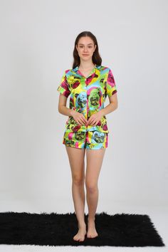 Step into comfort and fun with our Whimsical Pug Print Pajama Set, designed for the young at heart! This two-piece set features a playful pug face pattern in vibrant colors, including blue, pink, green, and yellow, all set against a bright turquoise backdrop. Perfect for lounging or bedtime, this short-sleeved button-up shirt and matching shorts offer a mix of style, comfort, and whimsy. 🌙 ✨ Unique Features ✨ 👕 Chic Design: Eye-catching pug prints add a dash of fun to your nightwear collection, with a playful twist that turns heads! 👚 Matching Set: The coordinated shirt and shorts make for a seamless, effortlessly stylish outfit. 🎨 High-Quality Digital Print: Using cutting-edge printing technology, the pug patterns stay vivid and sharp wash after wash. 💖 Ultimate Comfort: Crafted from Pug Face, Dog Faces, Cozy Sleepwear, Pyjama Satin, Face Pattern, Adult Pajamas, Bright Turquoise, Satin Pajamas, Young At Heart