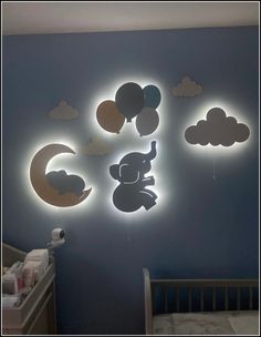 a baby's room with blue walls and clouds