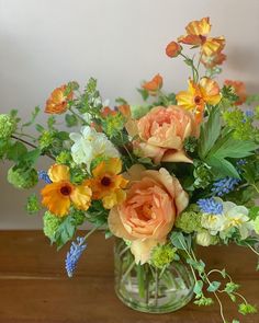 an arrangement of flowers in a glass vase