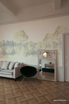 a living room with a couch, mirror and painting on the wall