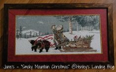 a cross - stitch picture of santa claus and his sleigh in the snow