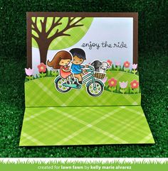 a card with a girl and boy riding a bike on the grass, says enjoy the ride