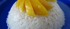 a plate with rice and mango slices on it