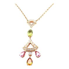 Bulgari Diva Dream 18k Rose Gold Diamond Peridot Necklace Cert  This necklace comes with Bulgari certificate of authenticity and Bulgari box.   Metal: 18k Rose Gold Measurements:  Length 17"  Pendant: 1 3/4" x 1/2" Weight: 12.1 grams Stones: Round brilliant cut diamonds Oval shape peridot Pear shape 2 pink tourmalines 1 topaz Hallmarks: Bvlgari Made in Italy 750 P1W533  Please reference the dimensions in the description for the best approximate dimensions. Elegant Multi-stone Diamond Necklace Gift, Elegant Pink Multi-stone Necklace, Multi-stone Diamond Necklace Gift, Peridot Necklace, Rose Gold Diamonds, Oval Diamond, Round Brilliant Cut Diamond, Pink Tourmaline, Pear Shape