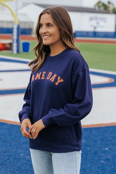 This game day sweatshirt is an essential for game days and everyday wear! Stay warm and stylish in our Navy Game day Graphic Sweatshirt! Made with 100% soft cotton, this long sleeve sweatshirt features a round neckline and ribbed cuffs for a comfortable fit. Simply style it with your favorite denim wear and sneakers to complete the look! Collegiate Team-colored Sweatshirt For Fall, Collegiate Sweatshirt For Game Day In Fall, Collegiate Style Sweatshirt For Game Day In Fall, Game Day Fan Apparel Sweatshirt For Fall, Varsity Sweatshirt For Fall Sports Events, Collegiate Long Sleeve Sweatshirt For Game Day, Team-colored Sweatshirt With Ribbed Cuffs For Fall, Fall Team Spirit Sweatshirt With Ribbed Cuffs, Team-colored Fall Sweatshirt With Ribbed Cuffs