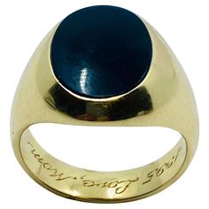 A vintage 14k gold signet ring featuring onyx. It’s a unisex ring with an oval face. Polished satin black gemstone is perfectly framed with a massive gold shank. The gold has a nice hue that is close to white gold, which works great with the onyx. This ring is as elegant as it’s smooth and well proportioned. DESIGNER: Tiffany & Co. MATERIALS: 14k Yellow Gold GEMSTONE: Onyx WEIGHT: 12.7 grams MEASUREMENTS: Top - 5/8" x 7/16" RING SIZE: 9.5 HALLMARKS: T & Co., 858 14k Gold Signet Ring, Gold Signet Ring, Oval Faces, Tiffany And Co, Unisex Ring, Signet Ring, Tiffany & Co., Vintage Gold, Onyx