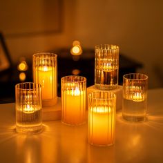 lit candles sitting on top of a table next to each other