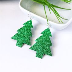 Looking to add a little fun to your holiday outfits? These adorably festive green glitter trees are the perfect lightweight faux leather earrings to compliment your style. It's the most wonderful time of the year! Deck the halls and trim the trees and don't forget your own festive accessories! The decorations you can take with you wherever you go all season long! These adorable earrings make perfect gifts for coworkers, teachers, neighbors, gift exchanges, and of course for yourself! These fun s Gifts For Coworkers Teachers, Festive Accessories, Glitter Christmas Tree, Faux Leather Earrings, Green Christmas Tree, Wonderful Time Of The Year, Glitter Christmas, Green Glitter, Gift Exchange