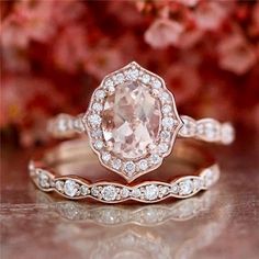 an engagement ring with a large pink diamond in the center and white diamonds around it