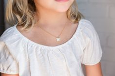 "Cute BUTTERFLY INITIAL necklace for little girls, toddler, or baby. This adorable initial necklace makes the perfect personalized gift for any girl, any age! They will smile with excitement when they unbox their very own cute initial necklace! It's simple, classic design will be popular and trendy for many years to come. Each matte gold or silver butterfly charm is strung from a sturdy diamond-cut chain. Strong enough to stand up against anything your little one may do! Your little one will be Cute Butterfly Necklace For Gift, Cute White Charm Necklace For Birthday Gift, Cute Butterfly Charm Necklace For Gift, White Hypoallergenic Necklace For Birthday, Cute White Custom Name Necklace, Cute White Necklace With Custom Name, Hypoallergenic White Necklace For Birthday, Hypoallergenic White Necklace For Personalized Gift, White Dainty Name Necklace For Birthday